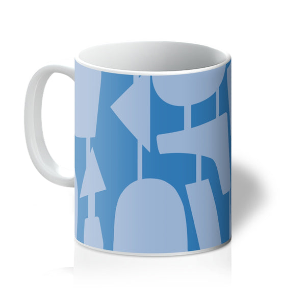This Mid-Century Modern style ceramic coffee mug consists of colorful connected shapes in Cerulean blue on a French blue background