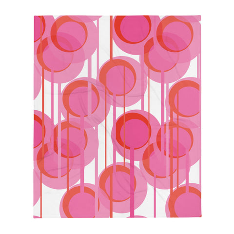 This Mid-Century Modern style throw blanket consists of colorful geometric circular shapes in various tones of pink, connected vertically by narrow tentacles to form and almost hanging mobile type abstract circular pattern on a white background