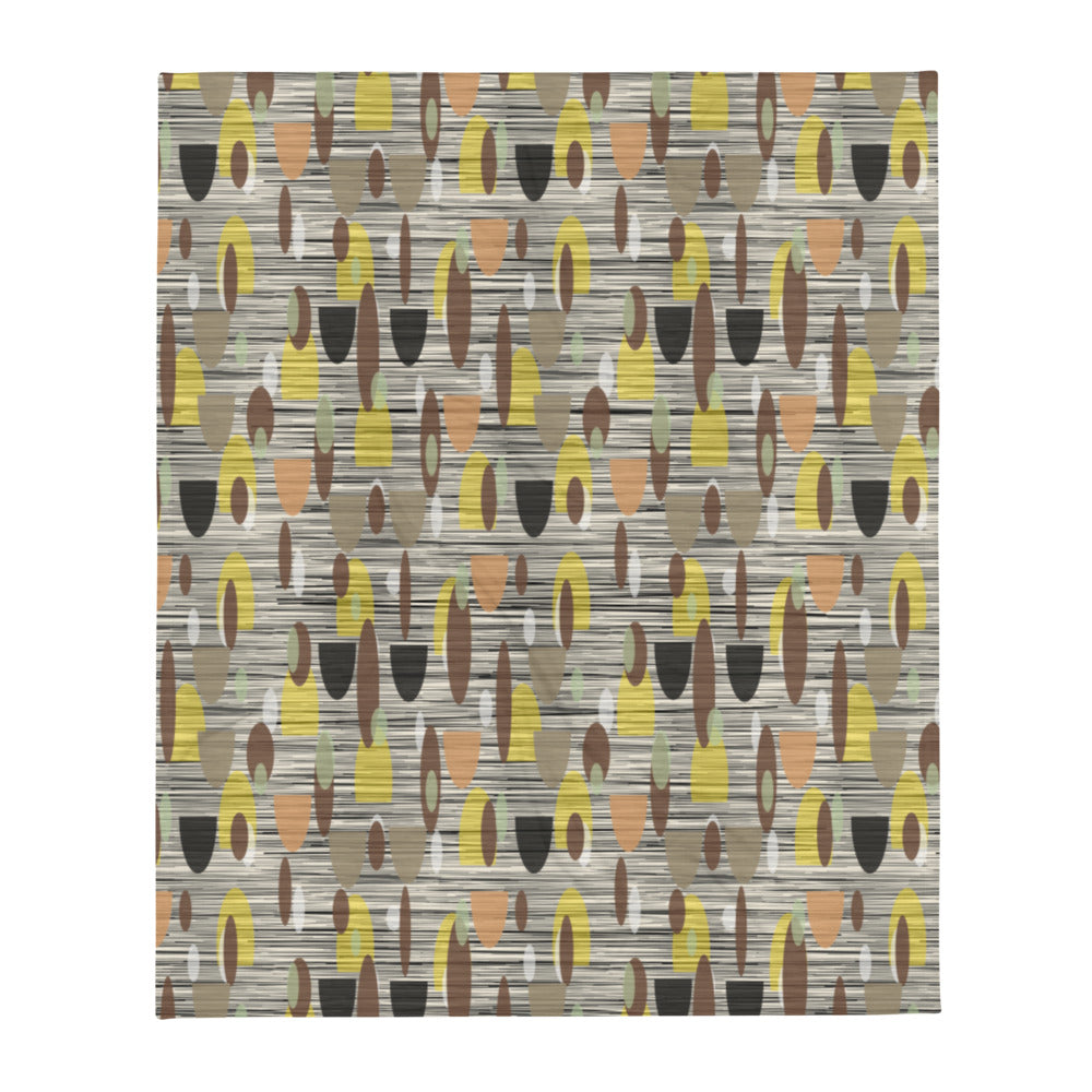 This Mid-Century Modern style couch throw design consists of a series of earthy muted oval shapes in browns, yellow, black and peach against a patterned background of black and grey crisscross and cream colours