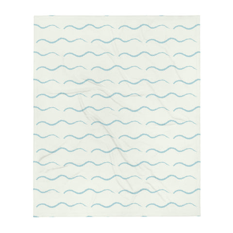 This retro style couch throw consists of a series of horizontal sea-foam blue wave shapes against a pale cream background