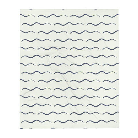 This retro style couch throw consists of a series of horizontal navy blue wave shapes against a pale cream background