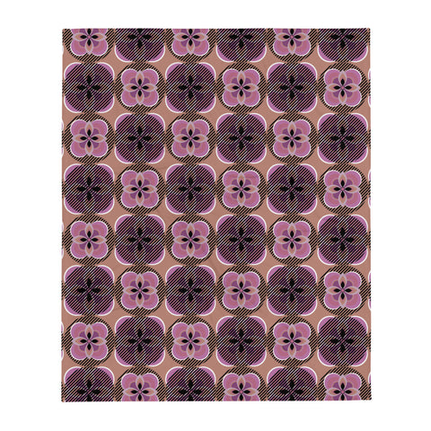 Contemporary pink Mid Century Modern / 70s vibe patterned throw blanket with abstract floral motifs on a pink background
