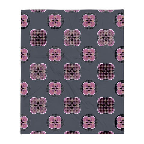 Contemporary pink Mid Century Modern / 70s vibe patterned throw blanket with abstract floral motifs on a grey background