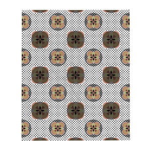 Contemporary orange Mid Century Modern / 70s vibe patterned throw blanket with abstract floral motifs on a dotted background