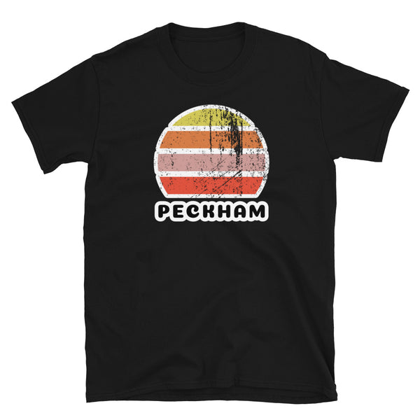 Vintage retro sunset in yellow, orange, pink and scarlet with the name Peckham beneath on this black t-shirt