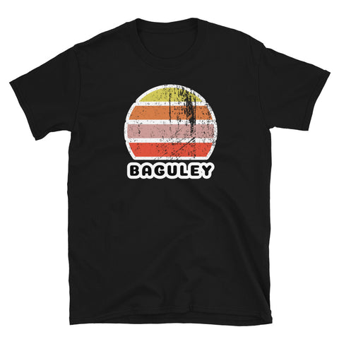 Distressed style abstract retro sunset graphic in yellow, orange, pink and scarlet stripes above the famous Manchester place name of Baguley on this black cotton t-shirt