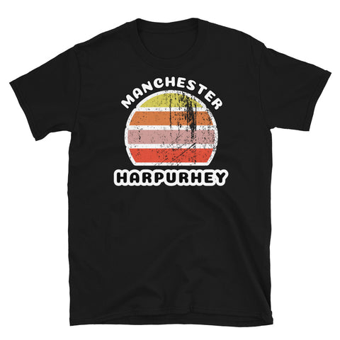 Distressed style abstract retro sunset graphic in yellow, orange, pink and scarlet stripes. The name of Manchester is displayed at the top wrapped around the sunset. Below the retro sunset design is the famous Manchester place name of Harpurhey on this black cotton t-shirt.