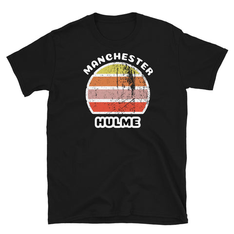 Distressed style abstract retro sunset graphic in yellow, orange, pink and scarlet stripes. The name of Manchester is displayed at the top wrapped around the sunset. Below the retro sunset design is the famous Manchester place name of Hulme on this black cotton t-shirt.