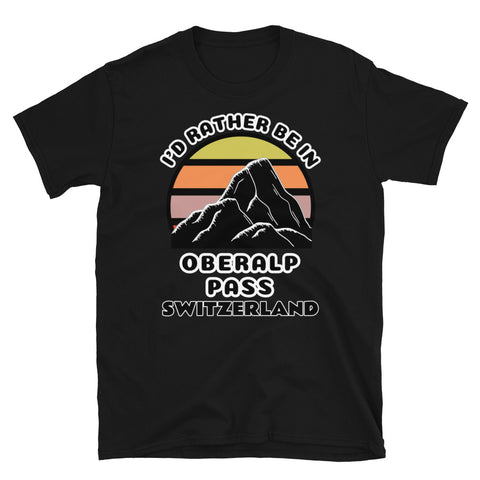 Oberalp Pass Switzerland vintage sunset mountain scene in silhouette, surrounded by the words I'd Rather Be In on top and Oberalp Pass, Switzerland below on this black cotton ski and mountain themed t-shirt