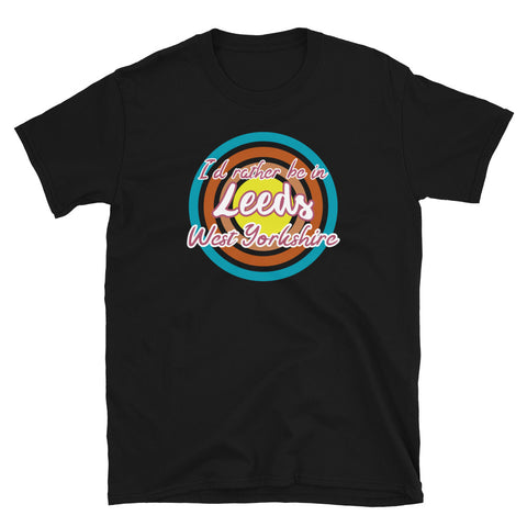 Leeds West Yorkshire urban city vintage style graphic in turquoise, orange, pink and yellow concentric circles with the slogan I'd rather be in Leeds West Yorkshire across the front in retro style font on this black cotton t-shirt