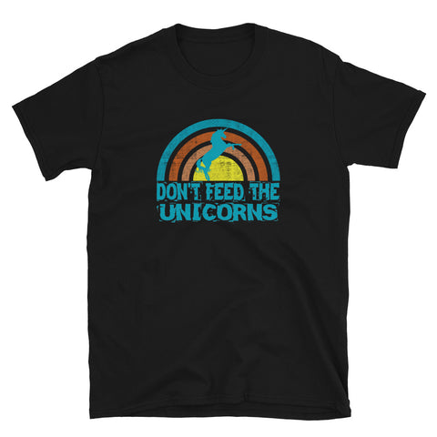 Cute don't feed the unicorns graphic tee featuring a turquoise unicorn in front of a vintage retro style sunset in distressed style turquoise, orange, pink and yellow and the slogan Don't Feed the Unicorns statement below on this black cotton t-shirt