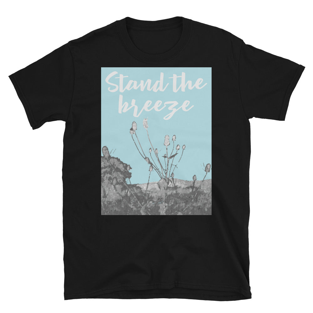 Stand the Breeze Graphic T-Shirt containing black and white landscape image of thistles in the West Sussex countryside against a pale blue skyline. The slogan Stand the Breeze is written above in pale grey script. on this black cotton t-shirt by BillingtonPix