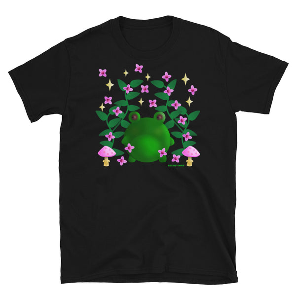 Cute kawaii green frog in this Cottagecore asesthetic graphic design. Features green leaves, pink blossom, grumpy mushrooms and stars in the sky on this black cotton t-shirt by BillingtonPix