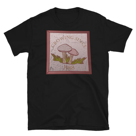 Growing since 1988 cute Goblincore style design with two mushrooms in muted tones and a glass framed effect with distressed look on this black cotton t-shirt by BillingtonPix