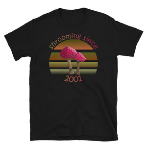 Shrooming since 2001 cute Goblincore style design with two red fly agaric mushrooms with distressed look against a multi-toned nature colour palette abstract vintage sunset design on this black cotton t-shirt by BillingtonPix