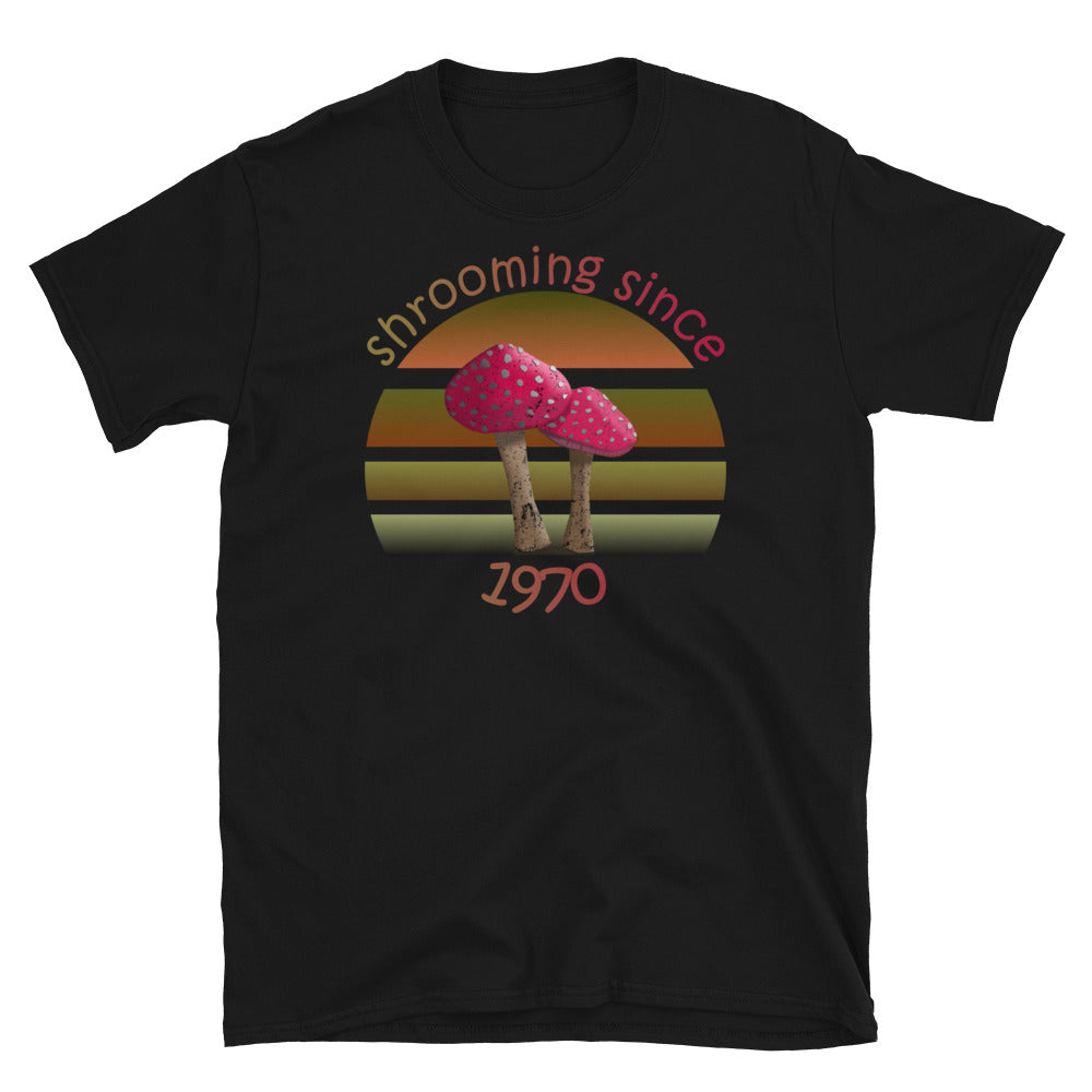 Shrooming since 1970 cute Goblincore style design with two red fly agaric mushrooms with distressed look against a multi-toned nature colour palette abstract vintage sunset design on this black cotton t-shirt by BillingtonPix