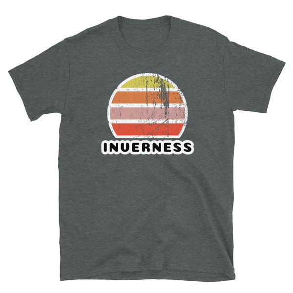 Distressed style abstract retro sunset graphic in yellow, orange, pink and scarlet stripes rising up from the famous Scottish place name of Inverness on this dark heather t-shirt