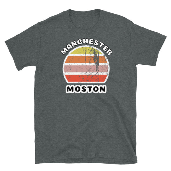 Distressed style abstract retro sunset graphic in yellow, orange, pink and scarlet stripes. The name of Manchester is displayed at the top wrapped around the sunset. Below the retro sunset design is the famous Manchester place name of Moston on this dark grey cotton t-shirt.