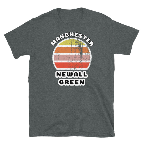 Distressed style abstract retro sunset graphic in yellow, orange, pink and scarlet stripes. The name of Manchester is displayed at the top wrapped around the sunset. Below the retro sunset design is the famous Manchester place name of Newall Green on this dark grey cotton t-shirt.
