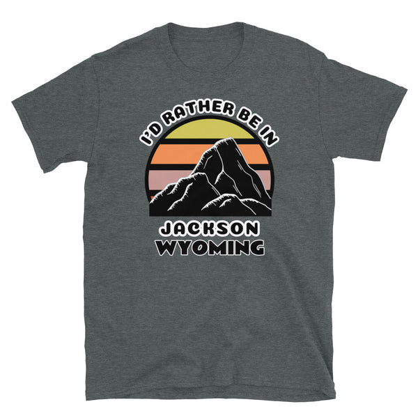Jackson, Wyoming vintage sunset mountain scene in silhouette, surrounded by the words I'd Rather Be In on top and Jackson, Wyoming below on this dark grey cotton t-shirt