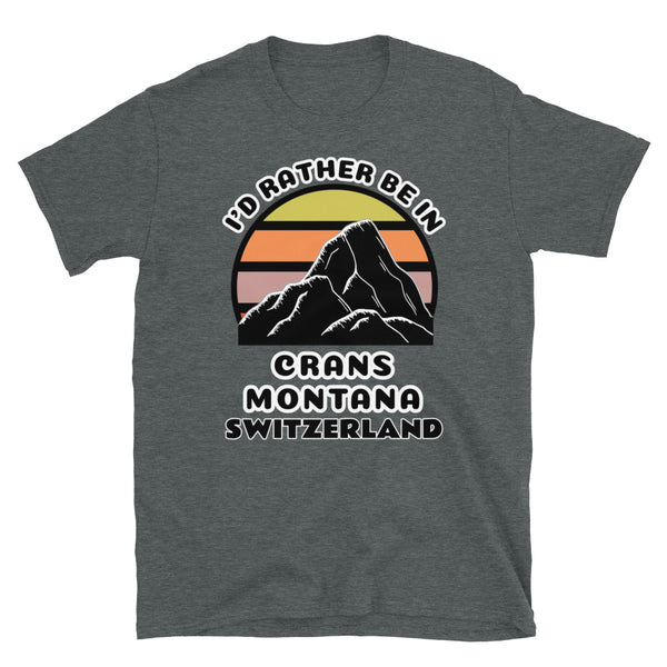 Crans-Montana Switzerland vintage sunset mountain scene in silhouette, surrounded by the words I'd Rather Be In on top and Crans Montana, Switzerland below on this dark grey cotton ski and mountain themed t-shirt