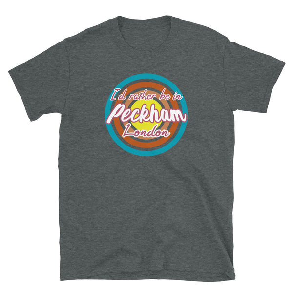 Urban vintage style graphic in turquoise, orange, pink and yellow concentric circles with the slogan I'd rather be in Peckham London across the front in retro style font on this dark grey cotton t-shirt