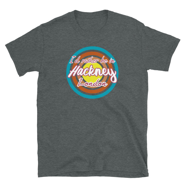 Hackney urban vintage style graphic in turquoise, orange, pink and yellow concentric circles with the slogan I'd rather be in Hackney London across the front in retro style font on this dark heather cotton t-shirt