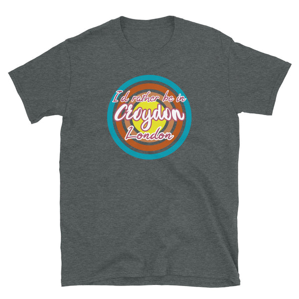 Croydon urban city vintage style graphic in turquoise, orange, pink and yellow concentric circles with the slogan I'd rather be in Croydon London across the front in retro vintage style font on this dark grey cotton t-shirt