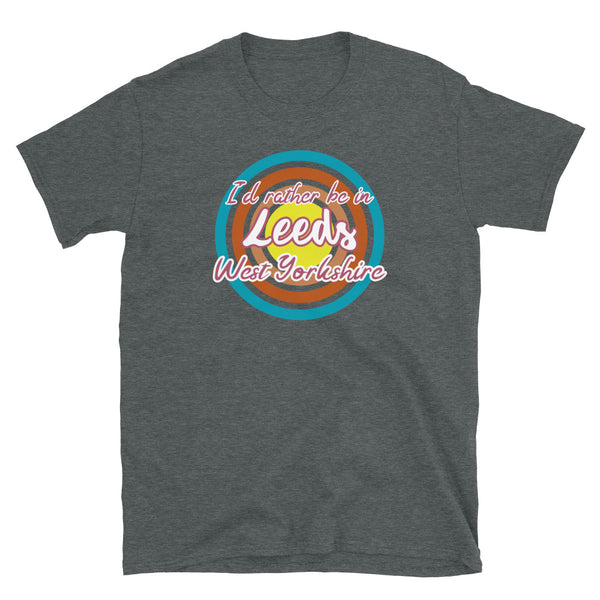 Leeds West Yorkshire urban city vintage style graphic in turquoise, orange, pink and yellow concentric circles with the slogan I'd rather be in Leeds West Yorkshire across the front in retro style font on this dark grey cotton t-shirt