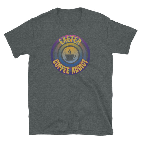 Concentric circular design of retro 80s metallic colours and the slogan Exeter Coffee Addict with a coffee cup silhouette in the centre. Distressed and dirty style image for a vintage Retrowave look on this dark grey cotton t-shirt by BillingtonPix