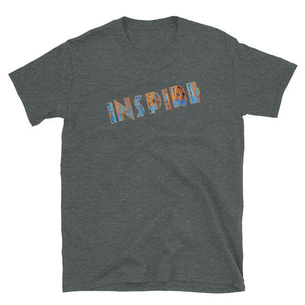 Inspirational slogan graphic t-shirt with the single word Inspire filled with vintage pattern burnt orange, turquoise blue and taupe tones and displayed on this dark grey cotton t-shirt by BillingtonPix in an energetic diagonal slant 