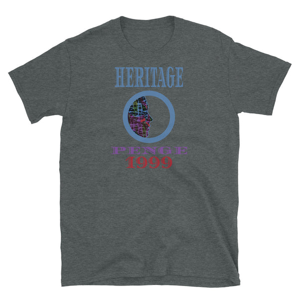 Graphic t-shirt with a patterned profile face in abstract design, tones of blue, green, purple, red, in circular format, with the words Heritage Penge 1999 in blue, purple and red on this dark heather cotton t-shirt by BillingtonPix