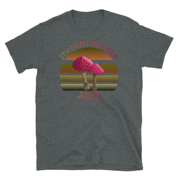 Shrooming since 2003 cute Goblincore style design with two red fly agaric mushrooms with distressed look against a multi-toned nature colour palette abstract vintage sunset design on this dark heather cotton t-shirt by BillingtonPix