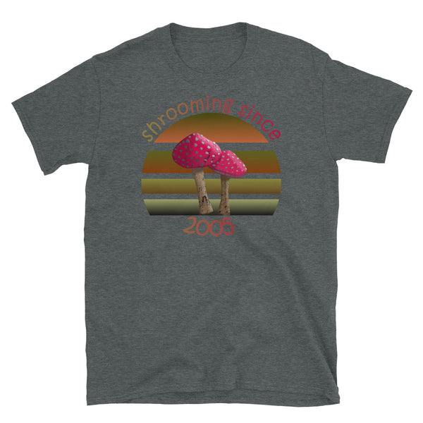 Shrooming since 2005 cute Goblincore style design with two red fly agaric mushrooms with distressed look against a multi-toned nature colour palette abstract vintage sunset design on this dark heather cotton t-shirt by BillingtonPix
