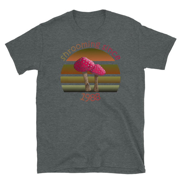 Shrooming since 1988 cute Goblincore style design with two red fly agaric mushrooms with distressed look against a multi-toned nature colour palette abstract vintage sunset design on this dark heather cotton t-shirt by BillingtonPix