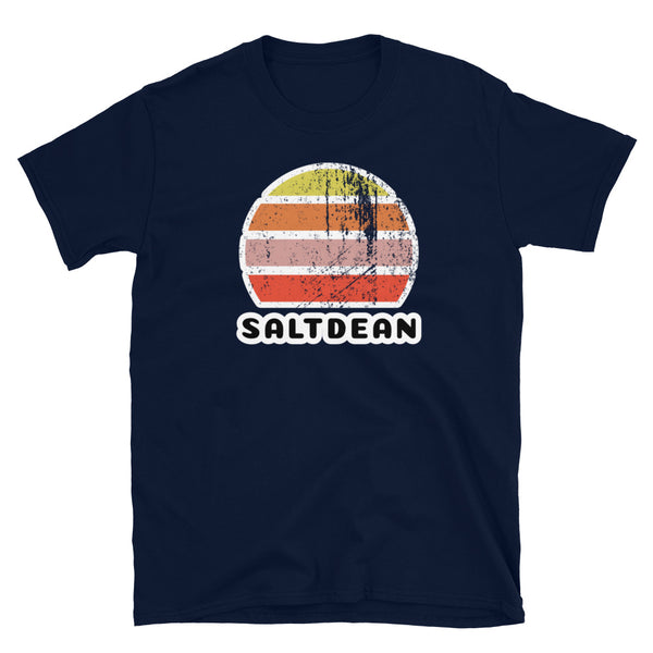 Features a distressed abstract retro sunset graphic in yellow, orange, pink and scarlet stripes rising up from the famous Brighton place name of Saltdean on this navy t-shirt