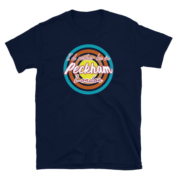Urban vintage style graphic in turquoise, orange, pink and yellow concentric circles with the slogan I'd rather be in Peckham London across the front in retro style font on this navy cotton t-shirt