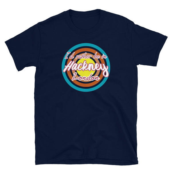 Hackney urban vintage style graphic in turquoise, orange, pink and yellow concentric circles with the slogan I'd rather be in Hackney London across the front in retro style font on this navy cotton t-shirt