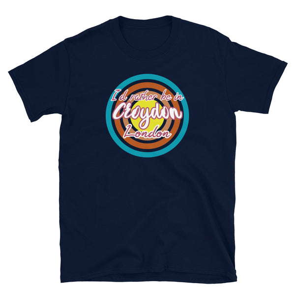 Croydon urban city vintage style graphic in turquoise, orange, pink and yellow concentric circles with the slogan I'd rather be in Croydon London across the front in retro vintage style font on this navy cotton t-shirt