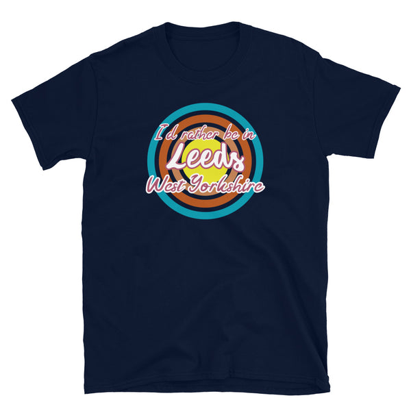 Leeds West Yorkshire urban city vintage style graphic in turquoise, orange, pink and yellow concentric circles with the slogan I'd rather be in Leeds West Yorkshire across the front in retro style font on this navy cotton t-shirt