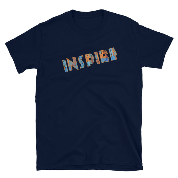 Inspirational slogan graphic t-shirt with the single word Inspire filled with vintage pattern burnt orange, turquoise blue and taupe tones and displayed on this navy cotton t-shirt by BillingtonPix in an energetic diagonal slant 