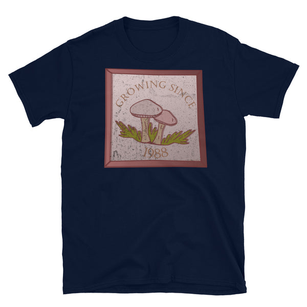 Growing since 1988 cute Goblincore style design with two mushrooms in muted tones and a glass framed effect with distressed look on this navy cotton t-shirt by BillingtonPix