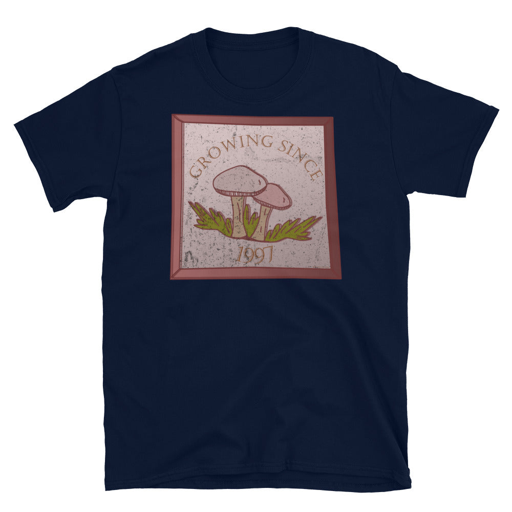 Growing since 1997 cute Goblincore style design with two mushrooms in muted tones and a glass framed effect with distressed look on this navy cotton t-shirt by BillingtonPix