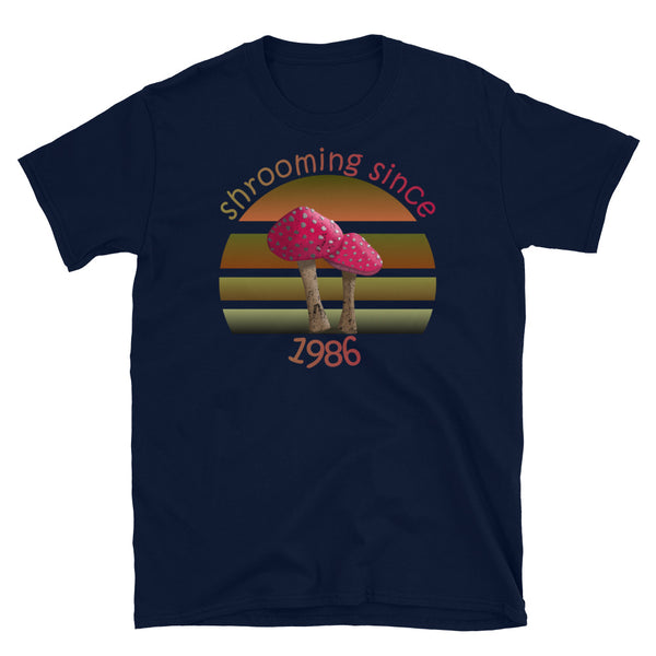Shrooming since 1986 cute Goblincore style design with two red fly agaric mushrooms with distressed look against a multi-toned nature colour palette abstract vintage sunset design on this navy cotton t-shirt by BillingtonPix