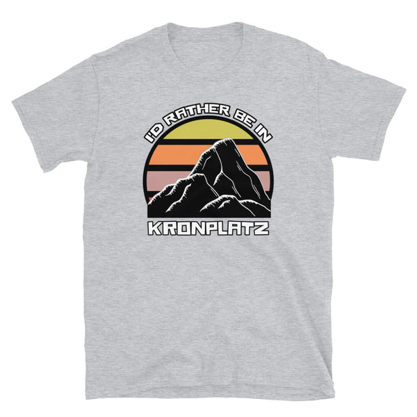 Abstract vintage sunset design with a black and white mountain design, and the words I'd Rather Be in Kronplatz on this sport grey t-shirt
