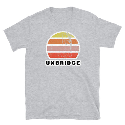 Vintage distressed style abstract retro sunset in yellow, orange, pink and scarlet with the name Uxbridge beneath on this sport grey t-shirt