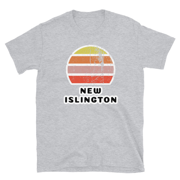 Features a distressed abstract retro sunset graphic in yellow, orange, pink and scarlet stripes rising up from the famous Manchester place name of New Islington on this sport grey t-shirt