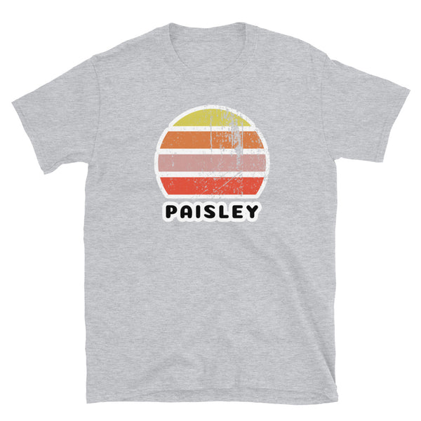 Distressed style abstract retro sunset graphic in yellow, orange, pink and scarlet stripes above the famous Scottish place name of Paisley on this sport grey t-shirt
