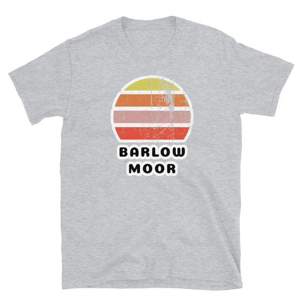 Distressed style abstract retro sunset graphic in yellow, orange, pink and scarlet stripes above the famous Manchester place name of Barlow Moor on this light grey cotton t-shirt