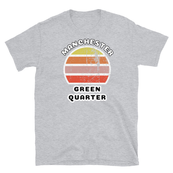 Distressed style abstract retro sunset graphic in yellow, orange, pink and scarlet stripes. The name of Manchester is displayed at the top wrapped around the sunset. Below the retro sunset design is the famous Manchester place name of Green Quarter on this light grey cotton t-shirt. 